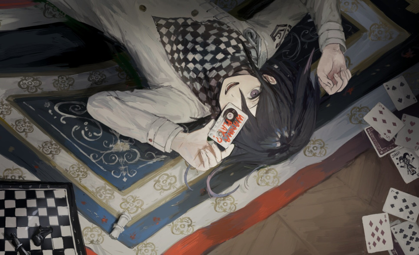 1boy ako_(td110349-7517) bangs black_hair card carpet cassette_tape checkered checkered_scarf chess_piece chessboard danganronpa hair_between_eyes highres holding long_sleeves lying male_focus new_danganronpa_v3 on_back open_mouth ouma_kokichi playing_card purple_eyes scarf solo straitjacket upside-down