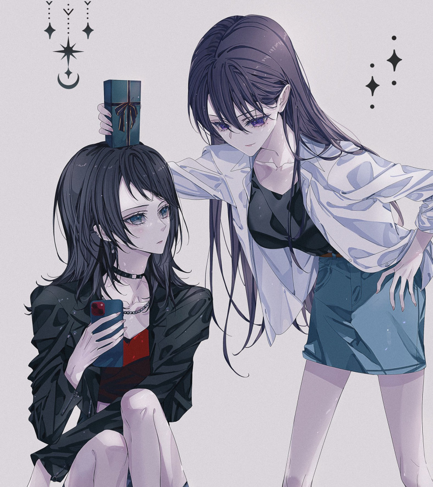 2girls bang_dream! bang_dream!_it's_mygo!!!!! belt black_choker black_hair black_jacket black_shirt blue_skirt box brown_belt cellphone chain_necklace choker closed_mouth collarbone commentary crop_top gift gift_box green_eyes grey_background hair_between_eyes hand_on_own_hip highres holding holding_phone jacket jewelry knees_up kourui_07 long_hair long_sleeves looking_at_another medium_hair midriff mole mole_under_eye multiple_girls necklace open_clothes open_jacket phone purple_eyes red_shirt shiina_taki shirt sitting skirt smartphone standing white_jacket yahata_umiri