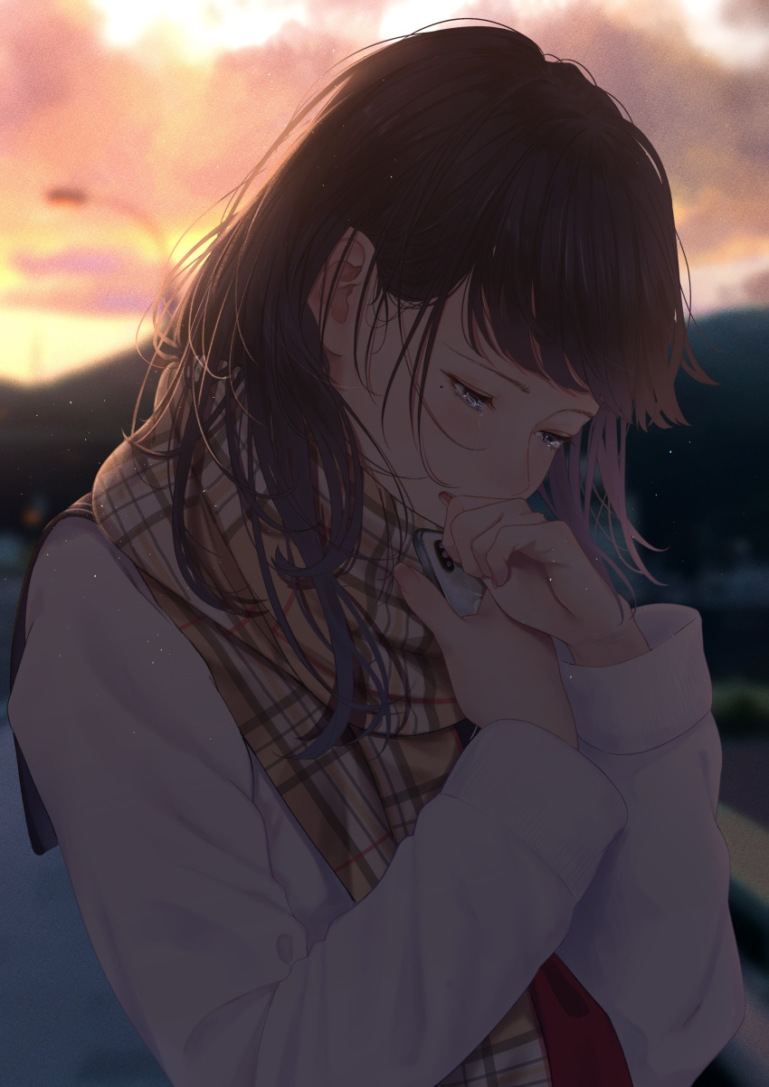 1girl absurdres bangs blurry blurry_background brown_hair cellphone cloud coat commentary_request crying crying_with_eyes_open hand_to_own_mouth highres holding holding_phone long_hair looking_down mole mole_under_eye open_mouth original outdoors phone plaid plaid_scarf saitou_(lynx-shrike) scarf sky smartphone standing sunset tears white_coat