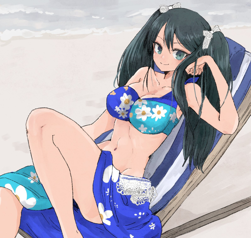 1girl beach bikini black_hair blue_bikini blue_eyes breasts chair collarbone commentary_request feet_out_of_frame floral_print groin highres isuzu_(kantai_collection) kantai_collection large_breasts long_hair looking_at_viewer lounge_chair navel sarong sitting smile solo swimsuit tori_knkr twintails