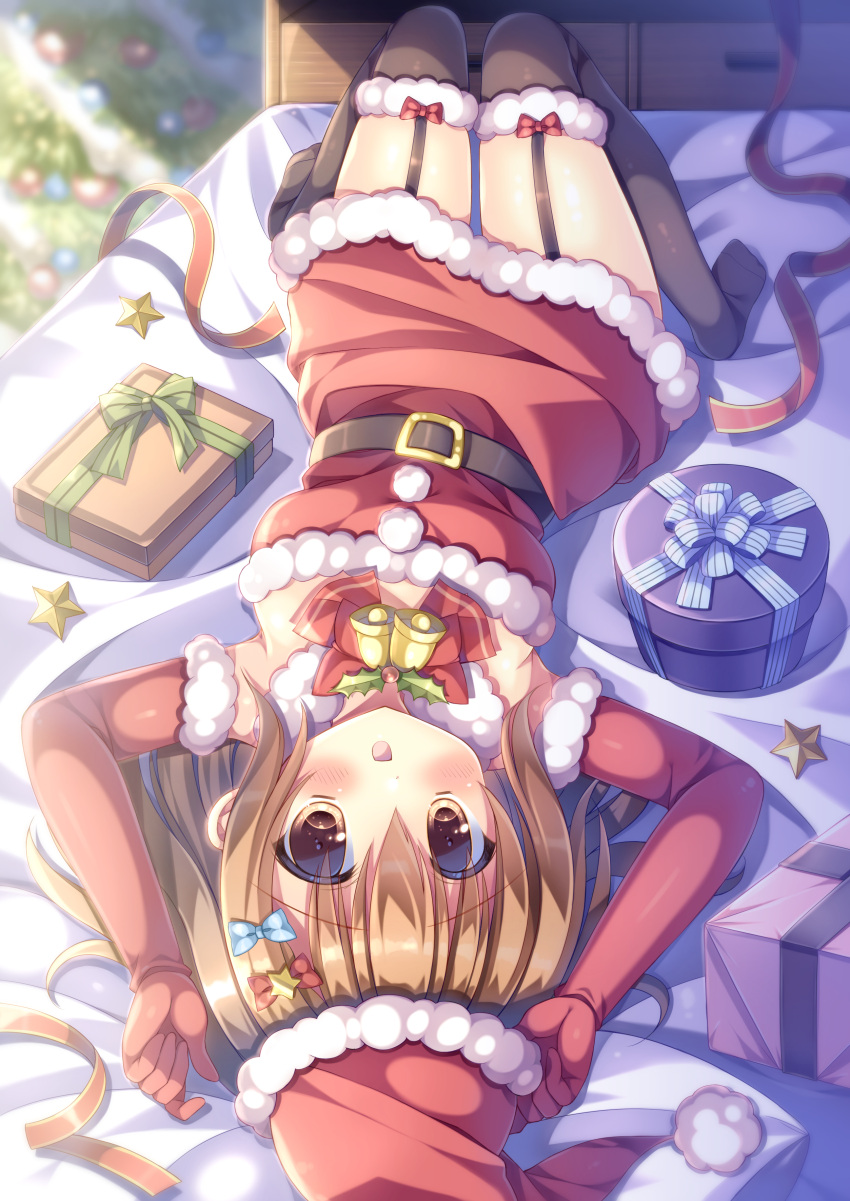 1girl :d absurdres arms_up bangs bed bell belt belt_buckle black_belt black_legwear blurry blurry_background blush bow box breasts brown_eyes brown_hair buckle christmas christmas_ornaments christmas_tree commentary_request depth_of_field dress elbow_gloves eyebrows_visible_through_hair fur-trimmed_gloves fur-trimmed_headwear fur-trimmed_legwear fur_trim garter_straps gift gift_box gloves hair_between_eyes hat highres kouta. long_hair looking_at_viewer medium_breasts no_shoes on_bed open_mouth original red_bow red_dress red_gloves red_headwear santa_costume santa_hat smile solo star_(symbol) strapless strapless_dress thighhighs