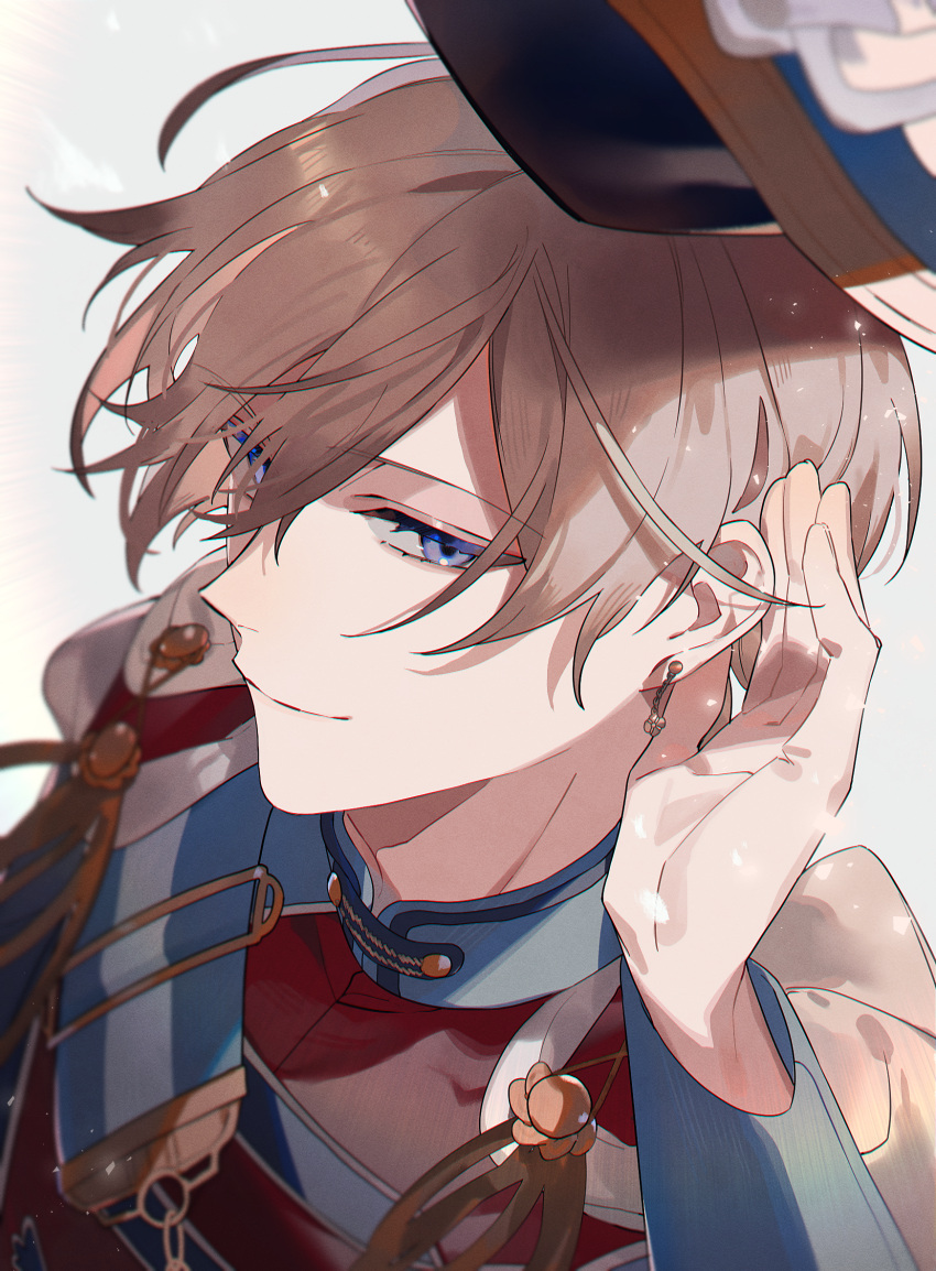 1boy band_uniform blue_eyes blurry brown_hair cape closed_mouth commentary_request depth_of_field earrings eyebrows_visible_through_hair face half-closed_eyes hand_on_ear hand_up hat highres jewelry light_particles light_smile long_sleeves looking_away looking_to_the_side mahoutsukai_no_yakusoku male_focus mandarin_collar rustica_(mahoutsukai_no_yakusoku) shako_cap short_hair shoulder_strap shuukenyuu sideways_glance solo white_cape