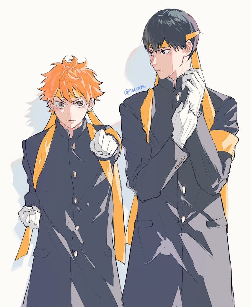 2boys 5600cm armband bangs black_hair buttons clenched_hand gakuran gloves haikyuu!! highres hinata_shouyou kageyama_tobio looking_at_viewer looking_away male_focus multiple_boys orange_hair ouendan school_uniform simple_background standing twintails white_gloves