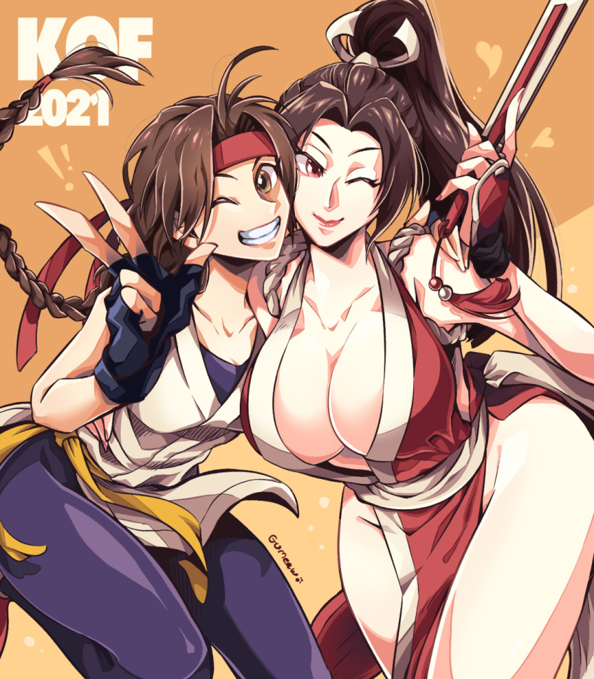 2girls breasts brown_eyes brown_hair closed_fan commentary dougi fan fatal_fury folding_fan grin headband high_ponytail highres holding holding_fan large_breasts looking_at_viewer multiple_girls one_eye_closed pelvic_curtain ponytail red_headband revealing_clothes ryuuko_no_ken shiranui_mai smile snk spandex teeth the_king_of_fighters user_nvca2775 v yellow_eyes yuri_sakazaki