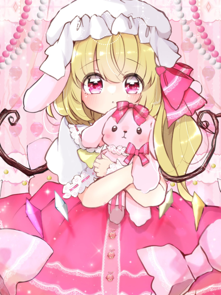 1girl animal_ears beads blonde_hair bow commentary_request cowboy_shot dot_nose dress dress_bow flandre_scarlet frilled_dress frilled_sleeves frilled_wrist_cuffs frills hair_bow hat highres hugging_doll hugging_object light_blush long_hair looking_at_viewer loose_hair_strand lop_rabbit_ears mob_cap ol07469724 open_mouth pink_background pink_dress pink_eyes pink_theme puffy_short_sleeves puffy_sleeves rabbit_ears short_sleeves side_ponytail solo stuffed_animal stuffed_rabbit stuffed_toy tareme touhou white_sleeves white_wrist_cuffs wings wrist_cuffs