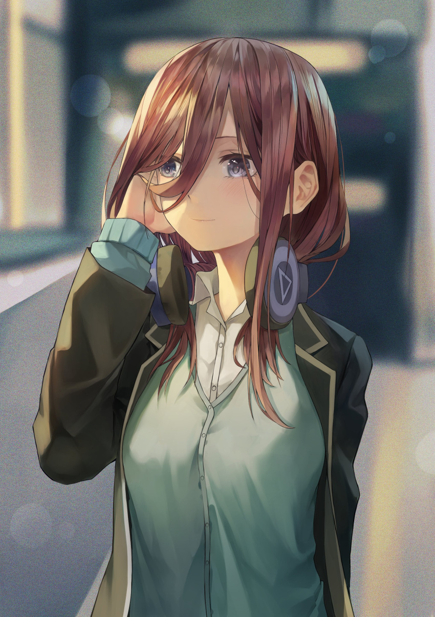 1girl absurdres bangs black_jacket blue_cardigan blue_eyes blurry blurry_background blush breasts brown_hair cardigan closed_mouth collared_shirt eyebrows_behind_hair fudepenbrushpen go-toubun_no_hanayome hair_behind_ear hair_between_eyes hand_on_ear headphones headphones_around_neck highres jacket long_hair looking_to_the_side nakano_miku school_uniform shirt smile solo upper_body white_shirt