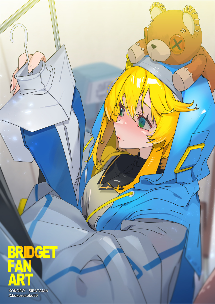 1boy blonde_hair blush bridget_(guilty_gear) green_eyes guilty_gear guilty_gear_strive guilty_gear_xx habit highres hood hood_up hooded_jacket hoodie jacket kokorokoko00 long_sleeves male_focus medium_hair open_clothes open_hoodie otoko_no_ko puffy_long_sleeves puffy_sleeves roger_(guilty_gear) smile stuffed_animal stuffed_toy teddy_bear