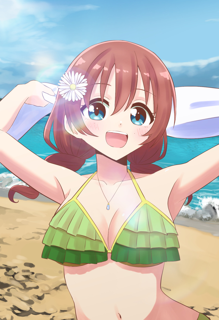 1girl :d arms_up beach bikini blue_eyes blue_sky braid breasts brown_hair collarbone commentary_request emma_verde flower freckles frilled_bikini_top green_bikini hair_flower hair_ornament highres holding holding_towel large_breasts looking_at_viewer love_live! love_live!_nijigasaki_high_school_idol_club medium_hair navel sky smile solo swimsuit teeth tera_dash tongue towel twin_braids upper_teeth_only white_flower