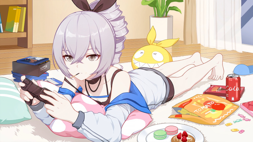 1girl bangs bare_shoulders barefoot book bookshelf bronya_zaychik can chips closed_mouth cola controller curtains drill_hair food fruit full_body grey_eyes grey_hair hair_between_eyes hair_ribbon highres holding holding_controller homu_(honkai_impact) honkai_(series) honkai_impact_3rd in_mouth indoors jacket liumang_tu_shua_p_zhan long_sleeves lying macaron on_stomach pillow plant plate playing_games pocky ribbon slippers soda_can solo strawberry sweets vase white_jacket window
