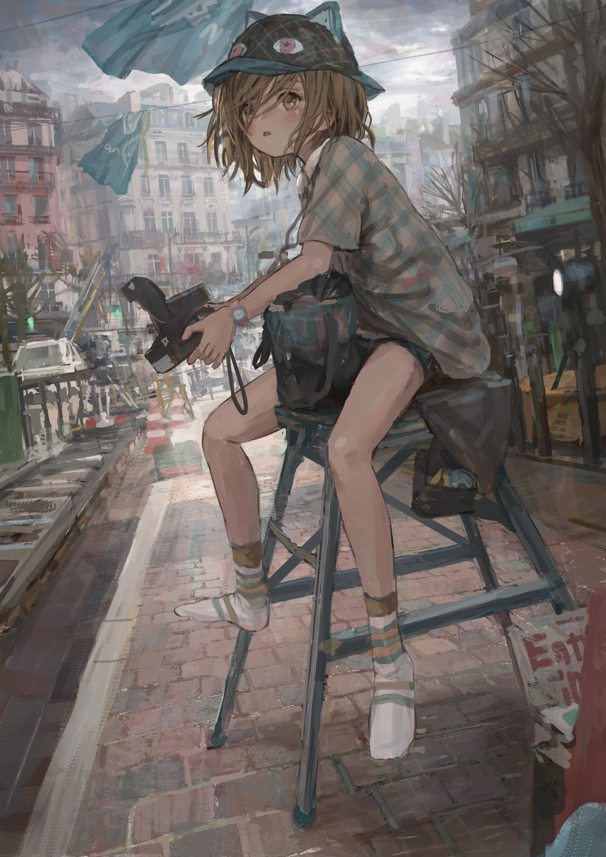 1girl absurdres animal_hat bag black_headwear blush brown_eyes brown_hair camera cityscape eye_print hat highres holding holding_camera open_mouth original outdoors polaroid road shion_(mirudakemann) short_hair shorts sitting socks solo stool street watch white_legwear