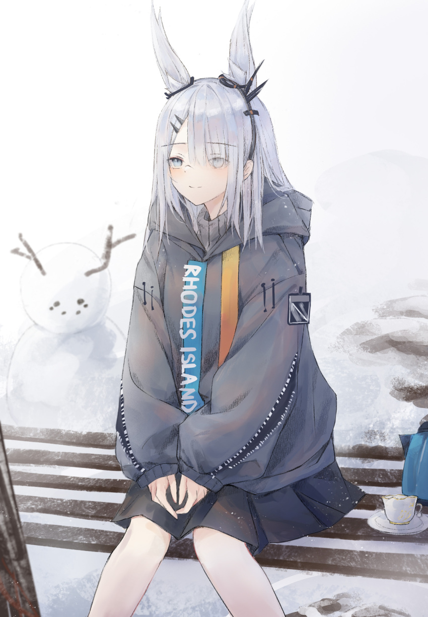 0_(znanimo) 1girl absurdres animal_ear_fluff animal_ears arknights bench black_skirt blush closed_mouth clothes_writing cup day eyebrows_visible_through_hair eyes_visible_through_hair feet_out_of_frame frostnova_(arknights) grey_eyes grey_hoodie hair_ornament hair_over_one_eye hairclip highres hood hood_up hoodie long_hair long_sleeves miniskirt outdoors rabbit_ears silver_hair sitting skirt smile snowman solo teacup teapot