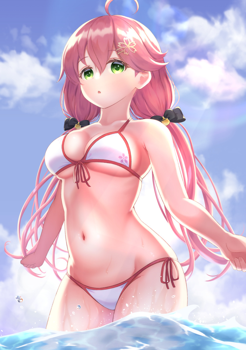 1girl absurdres ahoge alternate_costume bare_shoulders beach bikini black_ribbon blue_sky blush breasts cat_hair_ornament cleavage cloud cloudy_sky commentary day eyebrows_visible_through_hair green_eyes hair_between_eyes hair_ornament hairclip halterneck highres hololive long_hair looking_at_viewer navel ocean open_mouth parted_lips pink_hair ribbon sakura_miko side-tie_bikini sky solo sonao string_bikini swimsuit twintails underboob undersized_clothes virtual_youtuber water white_bikini