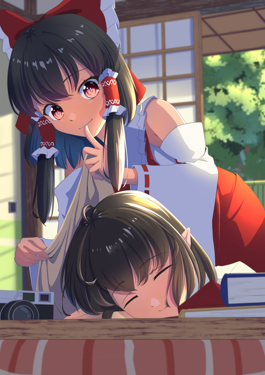 2girls amanoyayuki black_hair blanket book bow camera closed_eyes closed_mouth commentary_request covering_with_blanket detached_sleeves finger_to_mouth frilled_bow frilled_hair_tubes frills hair_bow hair_tubes hakurei_reimu hat highres long_hair multiple_girls no_headwear pointy_ears red_bow red_eyes red_hat ribbon-trimmed_sleeves ribbon_trim shameimaru_aya short_hair shouji shushing sleeping sliding_doors smile tokin_hat touhou unworn_headwear