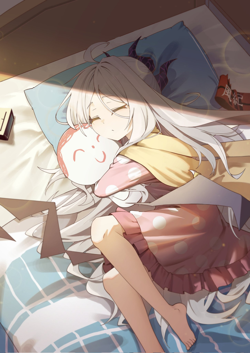 1girl ahoge alarm_clock armband barefoot bed blue_archive clock closed_eyes coat coat_on_shoulders curled_up doll gamer02153 highres hina_(blue_archive) hina_(pajamas)_(blue_archive) holding horns hug hugging_doll hugging_object lying on_bed pajamas pillow pink_pajamas pink_skirt skirt sleeping sunlight white_hair wings