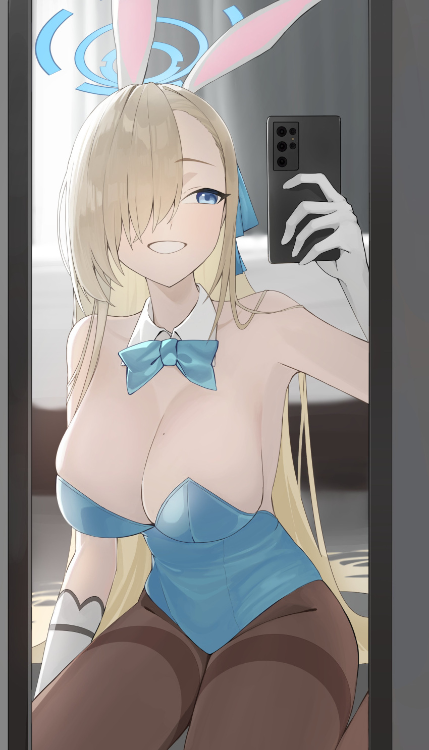 1girl absurdres animal_ears asuna_(blue_archive) asuna_(bunny)_(blue_archive) asymmetrical_bangs blonde_hair blue_archive blue_bow blue_bowtie blue_eyes blue_halo blue_leotard bow bowtie breasts cellphone fake_animal_ears gangjeong gloves hair_over_one_eye halo highres indoors leotard long_hair mirror mole mole_on_breast official_alternate_costume pantyhose phone playboy_bunny selfie strapless strapless_leotard thighband_pantyhose traditional_bowtie white_gloves