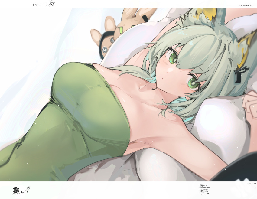 1girl animal_ear_fluff animal_ears arknights armpits arms_up bangs bare_shoulders blush breasts bright_pupils cat_ears cleavage dress eyebrows_visible_through_hair green_dress green_eyes green_hair highres kal'tsit_(arknights) large_breasts looking_at_viewer lying mikojin on_back parted_lips pillow short_hair signature solo strapless strapless_dress stuffed_animal stuffed_bunny stuffed_toy upper_body