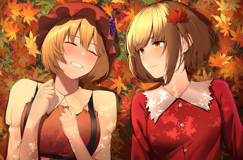 2girls absurdres aki_minoriko aki_shizuha apron blonde_hair breasts buttons closed_eyes closed_mouth collared_shirt fruit_hat_ornament grape_hat_ornament grin hair_ornament hat hat_ornament highres keenii_(kenny86) large_breasts leaf leaf_hair_ornament lying maple_leaf medium_breasts mob_cap multiple_girls on_back red_apron red_hat red_shirt shirt short_hair siblings sisters smile touhou yellow_eyes yellow_shirt