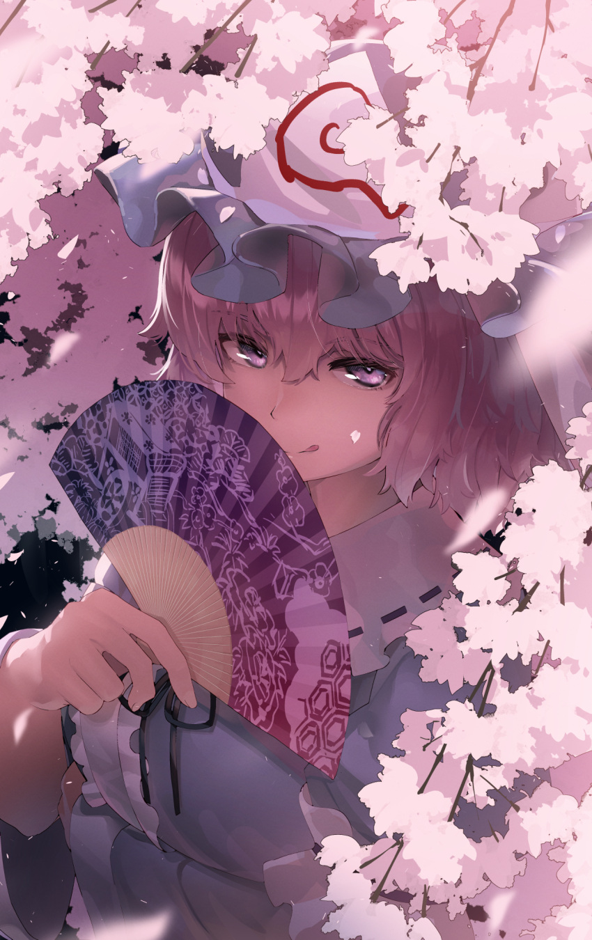 1girl :q arm_under_breasts bangs black_ribbon blue_headwear blue_kimono center_frills cherry_blossoms commentary folding_fan frilled_shirt_collar frills goshoguruma hair_between_eyes hand_fan hand_up hat highres holding holding_fan japanese_clothes kimono licking_lips light_purple_eyes looking_at_viewer mob_cap monosenbei neck_ribbon pink_eyes pink_hair ribbon ribbon-trimmed_collar ribbon_trim saigyouji_yuyuko saigyouji_yuyuko's_fan_design short_hair solo tongue tongue_out touhou triangular_headpiece upper_body wide_sleeves