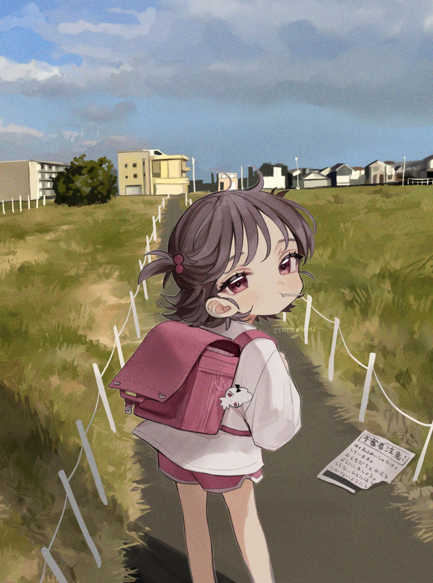 1girl artist_name backpack bag bag_charm bangs brown_hair building candy charm_(object) child closed_mouth cloud cloudy_sky day feet_out_of_frame film_grain flyer food from_behind grass hair_bobbles hair_ornament highres house ishita_umi lollipop long_sleeves looking_at_viewer looking_back original outdoors randoseru red_eyes red_shorts road shirt short_hair shorts sky solo standing translation_request two_side_up watermark white_shirt