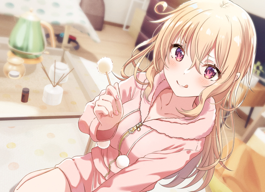 1girl bangs blonde_hair blurry blurry_background blush collarbone commentary_request commission couch ear_cleaning hair_between_eyes hand_up highres holding hood hoodie indoors licking_lips long_hair long_sleeves looking_at_viewer mimikaki original pajamas pink_hoodie red_eyes shiokazunoko sitting smile solo table tongue tongue_out