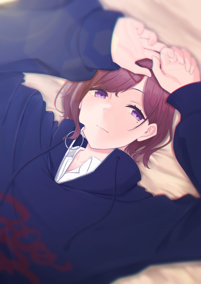 1girl :| absurdres arms_up bangs black_sweater blurry brown_hair closed_mouth depth_of_field highres higuchi_madoka idolmaster idolmaster_shiny_colors looking_at_viewer lying mole mole_under_eye on_stomach parted_bangs purple_eyes seseri_aoba short_hair solo sweater sweatshirt swept_bangs