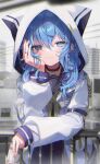  1girl against_railing arm_strap bangs black_choker blue_eyes blue_hair blush bow choker city closed_mouth cowboy_shot day earrings eyebrows_visible_through_hair hand_on_own_cheek hand_on_own_face holding hololive hood hood_up hooded_jacket hoshimachi_suisei jacket jewelry juice_box light_particles long_hair long_sleeves looking_at_viewer open_clothes open_jacket outdoors railing shiohana sleeves_past_wrists smile solo star_(symbol) white_jacket yellow_bow 