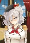 1girl bangs beret black_headwear blue_eyes blurry blurry_background blush box breasts cardboard_box closed_mouth curtains dated epaulettes grey_hair hair_between_eyes hat indoors kancolle_arcade kantai_collection kashima_(kancolle) large_breasts long_hair looking_at_viewer military military_uniform mimamui solo twintails twitter_username uniform upper_body wavy_hair window 