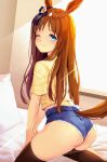  1girl ;) absurdres animal_ears ass backlighting black_legwear bloody0rabby blue_shorts blush brown_hair closed_mouth commentary grass_wonder_(umamusume) highres horse_ears horse_girl horse_tail indoors long_hair looking_at_viewer looking_back on_bed one_eye_closed pillow revision shirt short_shorts short_sleeves shorts smile solo sunlight sweat tail thighhighs umamusume very_long_hair window yellow_shirt 