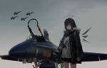  1girl aircraft airplane arknights bangs black_hair black_jacket blue_angels blue_eyes camera closed_mouth commentary detached_wings english_commentary f/a-18e_super_hornet fighter_jet fur_trim halo highres holding holding_camera horns id_card jacket jet long_hair long_sleeves looking_at_viewer military military_vehicle mirroraptor mostima_(arknights) open_clothes open_jacket outdoors shirt smile solo standing united_states_navy white_shirt wings 
