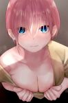  1girl asymmetrical_hair blue_eyes breasts brown_background cleavage clothes_pull collarbone earrings eyebrows_visible_through_hair from_above go-toubun_no_hanayome highres jewelry looking_at_viewer mame1645 nakano_ichika pink_hair shirt_pull short_hair solo upper_body 