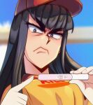  1girl angry arwald bangs baseball_cap black_hair blue_eyes blurry blurry_background burger_king employee_uniform frown furrowed_brow hat highres hime_cut holding implied_pregnancy kill_la_kill kiryuuin_satsuki long_hair looking_at_viewer pointing portrait pregnancy_test red_headwear shirt sidelocks solo symbol-only_commentary thick_eyebrows uniform v-shaped_eyebrows yellow_shirt 