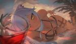  1girl animal_ears armpits bangs between_legs bikini black_bikini black_ribbon blurry blurry_foreground blush breasts cleavage closed_mouth cloud cloudy_sky cup dagger dark-skinned_female dark_skin day depth_of_field drinking_glass eyebrows_visible_through_hair grey_hair highres hololive kanchigai knife large_breasts lion_ears lion_girl lion_tail long_hair looking_at_viewer on_bed outdoors ribbon shallow_water shishiro_botan side-tie_bikini skindentation sky smile solo swimsuit tail tail_between_legs thigh_gap thigh_strap water weapon yellow_eyes 