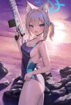  1girl :d absurdres animal_ear_fluff animal_ears blue_archive blue_eyes blue_swimsuit blush breasts cross_hair_ornament dong_ji from_side grey_hair gun hair_ornament halo highres holding holding_gun holding_weapon medium_breasts ocean one-piece_swimsuit outdoors rock shiroko_(blue_archive) sky smile solo swimsuit weapon 