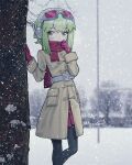  1girl aegissanp artist_name bangs blush coat covered_mouth duffel_coat gloves goggles goggles_on_head green_eyes green_hair gumi hands_up headphones highres leaning_on_object long_sleeves looking_to_the_side pantyhose photo_background pleated_skirt scarf scarf_over_mouth short_hair_with_long_locks sidelocks skirt snow snowing solo tree vocaloid winter winter_clothes 