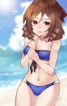  1girl beach bikini blue_bikini blue_sky blush bow breasts brown_hair cloud cloudy_sky cosplay cowboy_shot day drill_hair embarrassed hair_between_eyes hair_bow harukaze_(kancolle) johnston_(kancolle) johnston_(kancolle)_(cosplay) kantai_collection navel ocean outdoors red_bow red_eyes sand sky small_breasts solo sunlight swimsuit twin_drills u_yuz_xx water wavy_mouth 