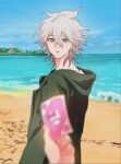  1boy baba_(sizennha_pan2) bangs beach blue_sky blurry blurry_foreground card danganronpa_(series) danganronpa_2:_goodbye_despair green_jacket grey_eyes grey_hair holding holding_card hood hood_down hooded_jacket jacket komaeda_nagito long_sleeves male_focus monomi_(danganronpa) ocean outdoors shirt sky solo_focus water 