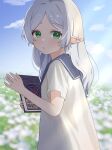  1girl 8_nana_usagi blue_sky blurry blurry_background book cloud commentary_request day depth_of_field earrings elf field flower flower_field frieren green_eyes highres holding holding_book jewelry long_hair looking_at_viewer outdoors parted_bangs parted_lips pointy_ears shirt short_sleeves sky solo sousou_no_frieren white_hair white_shirt 
