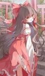  1girl absurdres barefoot bow brown_eyes brown_hair chinese_commentary commentary detached_sleeves feet frilled_bow frilled_hair_tubes frills hair_bow hair_tubes hakurei_reimu highres leg_up long_hair looking_at_viewer ningmeng_jing_jing_jing_jing open_mouth outdoors red_bow red_skirt ribbon-trimmed_sleeves ribbon_trim skirt skirt_set smile soles stairs standing standing_on_one_leg toes torii touhou very_long_hair 