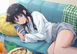  1girl black_hair brown_eyes chips_(food) commentary_request couch cowboy_shot cup drinking_straw food grey_shorts head_on_pillow highres holding holding_phone isshokuitaru juice long_hair looking_at_phone lying midriff_peek on_couch on_side open_mouth orange_juice original phone pillow potato_chips red_eyes shirt shorts solo thighs white_shirt yellow_pillow 