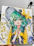  1girl :d absurdres black_hat bow buttons chinese_commentary collared_shirt commentary_request diamond_button disembodied_linked_eye eyeball frilled_shirt_collar frilled_sleeves frills green_eyes green_hair hat hat_bow highres komeiji_koishi l0e9s29p long_sleeves looking_at_viewer photo_(medium) shikishi shirt smile solo touhou touhou_22nd_popularity_poll traditional_media translation_request upper_body wide_sleeves yellow_bow yellow_shirt 