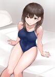 1girl bed blue_one-piece_swimsuit breasts brown_eyes brown_hair competition_school_swimsuit covered_navel feet_out_of_frame highres looking_at_viewer medium_breasts nobita_(nbnobita) one-piece_swimsuit original pillow school_swimsuit solo swimsuit 