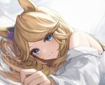  1girl animal_ears bangs bed_sheet blue_eyes blurry blush bra_strap closed_mouth depth_of_field gold_city_(umamusume) highres horse_ears long_hair long_sleeves looking_at_viewer lying off_shoulder on_side reaching_out shino_sto shirt smile solo split_mouth umamusume upper_body white_shirt 