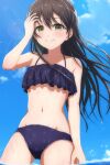  1girl bang_dream! bikini black_hair blush from_below green_eyes groin hair_between_eyes hanazono_tae hand_in_own_hair hand_up highres lens_flare long_hair looking_at_viewer navel noshimurin outdoors sky smile solo swimsuit wading water wet 