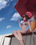  1girl absurdres animal_ear_fluff animal_ears arm_support bangs bare_arms bare_legs bare_shoulders beach_umbrella bikini blue_archive blue_shorts blue_sky blush breasts brown_hair chun_bae cloud commentary day food fox_ears fox_tail halo hand_up highres holding holding_food izuna_(blue_archive) medium_breasts navel outdoors popsicle red_umbrella short_hair short_shorts shorts sitting sky solo stomach striped striped_bikini swimsuit tail umbrella visor_cap 