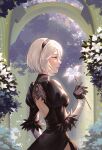  1girl absurdres back_cutout black_dress black_gloves black_hair blue_eyes bob_cut breasts clothing_cutout courtyard cowboy_shot dress feather_trim flower garden gloves hair_between_eyes high_collar highres holding holding_flower looking_to_the_side medium_breasts nier_(series) nier_automata parted_lips profile side_slit solo white_hair yorha_no._2_type_b yubuki_i 