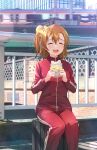  2girls bangs bow bridge closed_eyes commentary day food ground_vehicle hair_between_eyes hair_bow happy highres holding holding_food kousaka_honoka light_blush love_live! love_live!_school_idol_project medium_hair multiple_girls open_mouth orange_hair outdoors railing red_track_suit shamakho side_ponytail smile solo_focus sonoda_umi track_suit train yellow_bow 