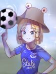  1girl absurdres alternate_costume ball blonde_hair blue_eyes blue_shirt blurry brown_headwear closed_mouth clothes_writing depth_of_field everton_fc highres index_finger_raised kalejdodatabase moriya_suwako shirt short_hair short_sleeves sidelocks smile soccer_ball soccer_uniform solo sportswear touhou upper_body 