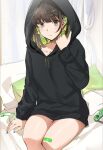  1girl bandaid bandaid_on_leg black_hoodie blue_nails brown_eyes brown_hair closed_mouth cushion earrings highres hood hoodie jewelry looking_at_viewer mole mole_on_thigh mole_under_eye nintendo_switch no_pants original ormille sitting solo thighs 
