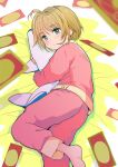  1girl antenna_hair barefoot blush brown_hair cardcaptor_sakura clow_card green_eyes highres holding holding_stuffed_toy kinomoto_(nazonoinu) kinomoto_sakura looking_at_viewer lying object_hug pajamas pink_pajamas short_hair solo stuffed_animal stuffed_shark stuffed_toy 