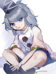 1girl bare_legs blue_eyes crossed_ankles eyebrows_hidden_by_hair grey_hair hand_on_own_foot hat highres japanese_clothes kariginu looking_at_viewer mononobe_no_futo oishiinori_1248 pom_pom_(clothes) ponytail ribbon-trimmed_sleeves ribbon_trim simple_background sitting solo tate_eboshi touhou white_background 